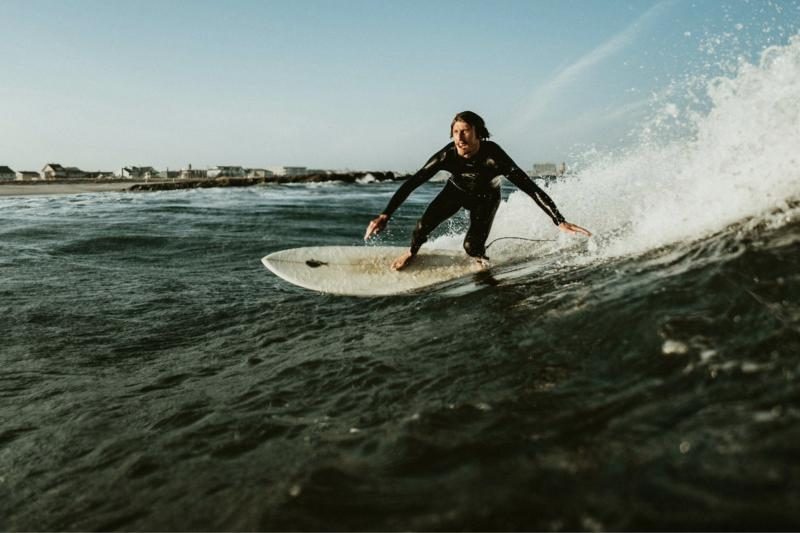 A surfer riding across a wave